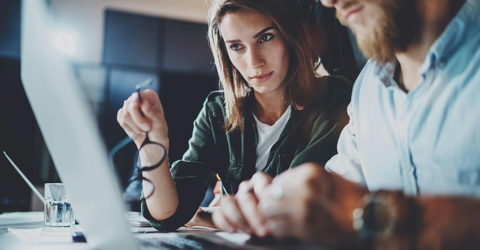 two people working at a laptop