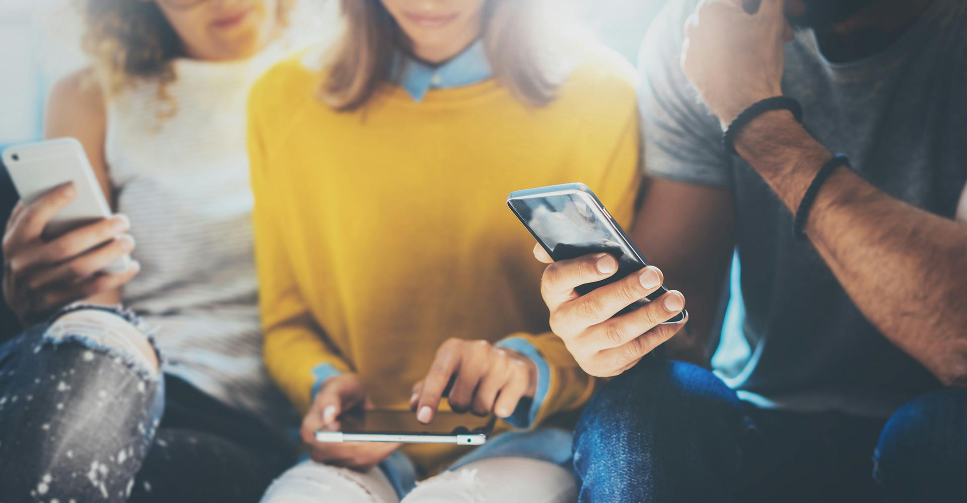 three people using their phones