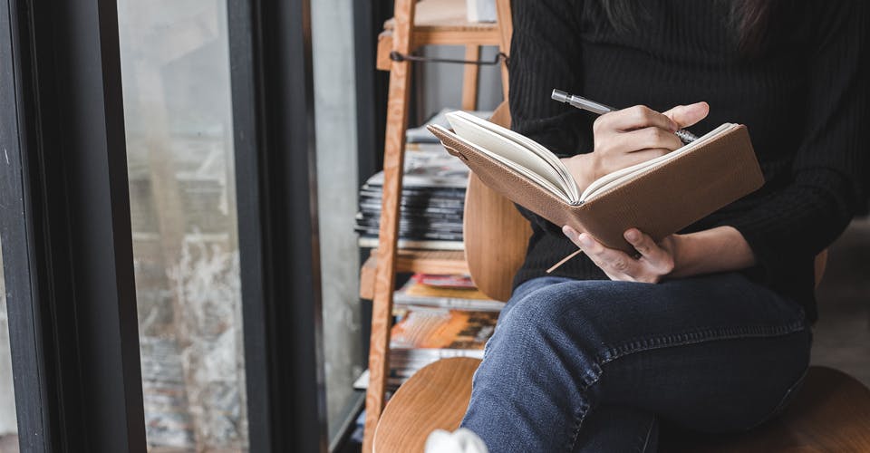 person writing a book